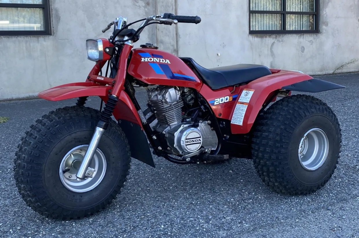 Discover the ATC200S, Honda’s versatile sport-utility 3-wheeler featuring a 182cc 4-stroke engine, 5-speed auto-clutch transmission, and trail-ready design.